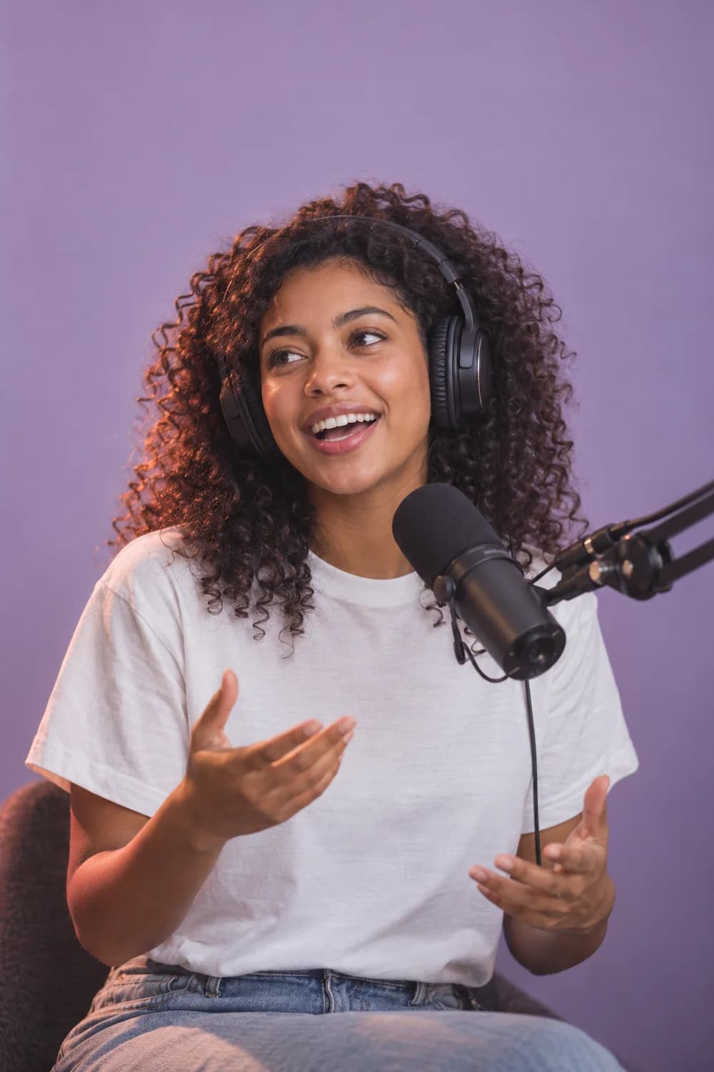 Podcast creator speaking into a studio microphone